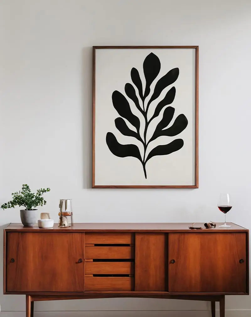 A minimalist illustration of black abstract leaves on a light background. Perfect wall art for modern interiors and lovers of simple, elegant designs