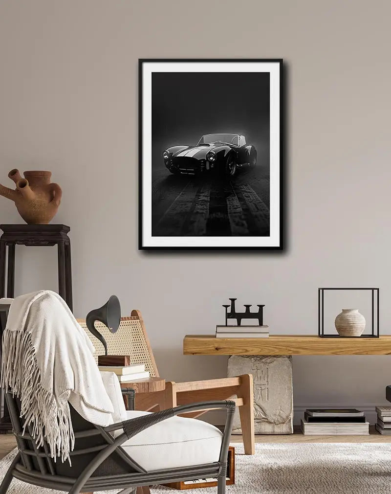 A striking black and white wall art poster featuring a vintage sports car in dramatic lighting, highlighting its sleek curves and classic design. Perfect for car enthusiasts or as a stylish decoration in a modern or industrial-themed space