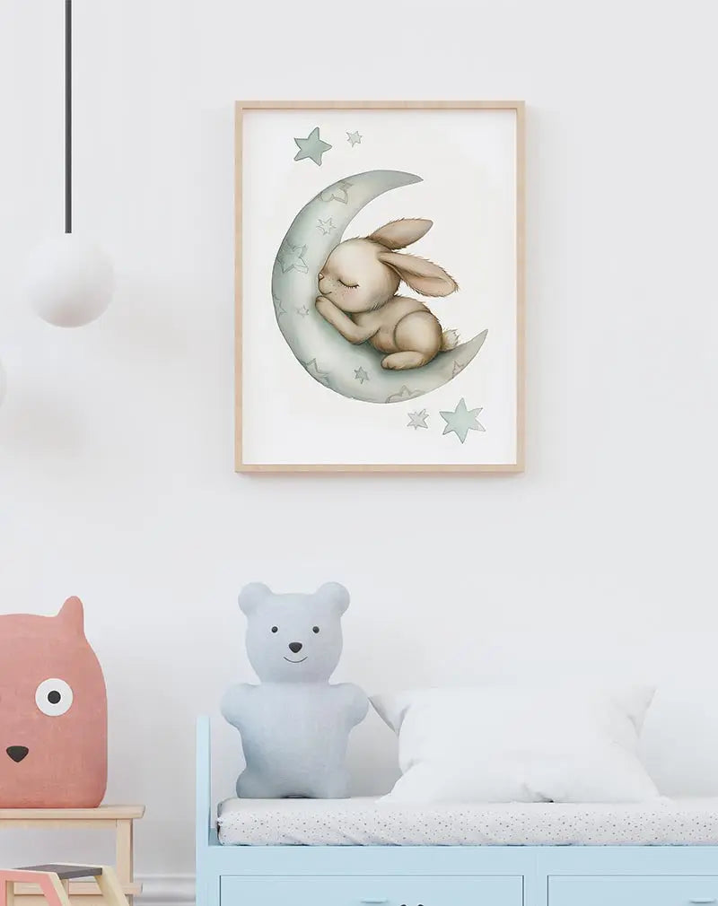 A cute bunny sleeping on a crescent moon surrounded by stars. Perfect wall art for creating a calm and cozy nursery atmosphere