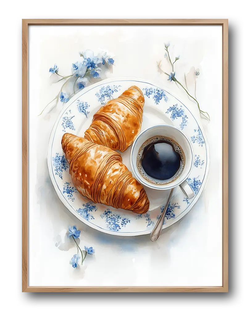 A delicate illustration of two croissants and a cup of coffee on a blue floral plate. Perfect wall art for creating a cozy, French café atmosphere in your kitchen or dining area