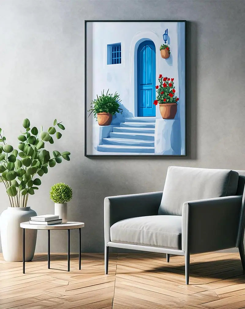 A charming Mediterranean scene featuring a bright blue door, white stucco walls, and vibrant red flowers in terracotta pots. This picturesque wall art brings a touch of coastal elegance to your home decor, perfect for evoking a peaceful, sunny atmosphere