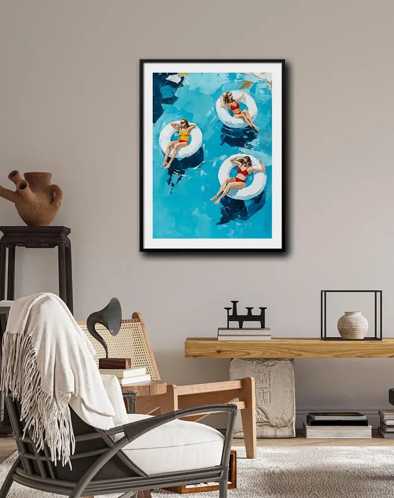 A vibrant illustration of three women floating on inflatable rings in a pool, enjoying the summer sun. Perfect wall art for brightening up any space with a relaxing vacation vibe, ideal for pool lovers