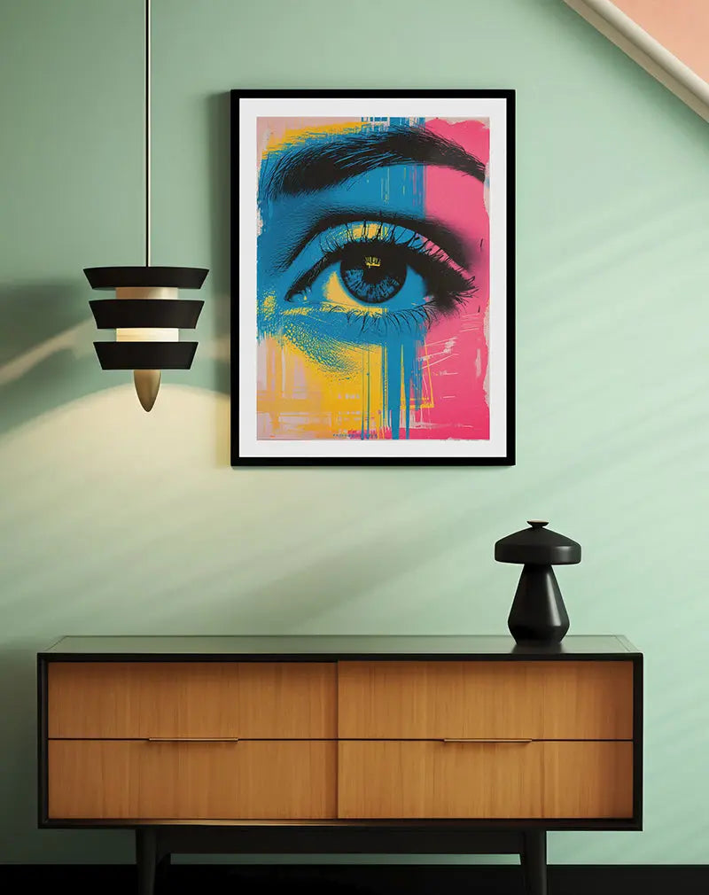 A bold and colorful abstract illustration of an eye, blending blue, pink, and yellow hues in a modern art style. Perfect wall art for contemporary spaces, adding a touch of creativity and intrigue to your room