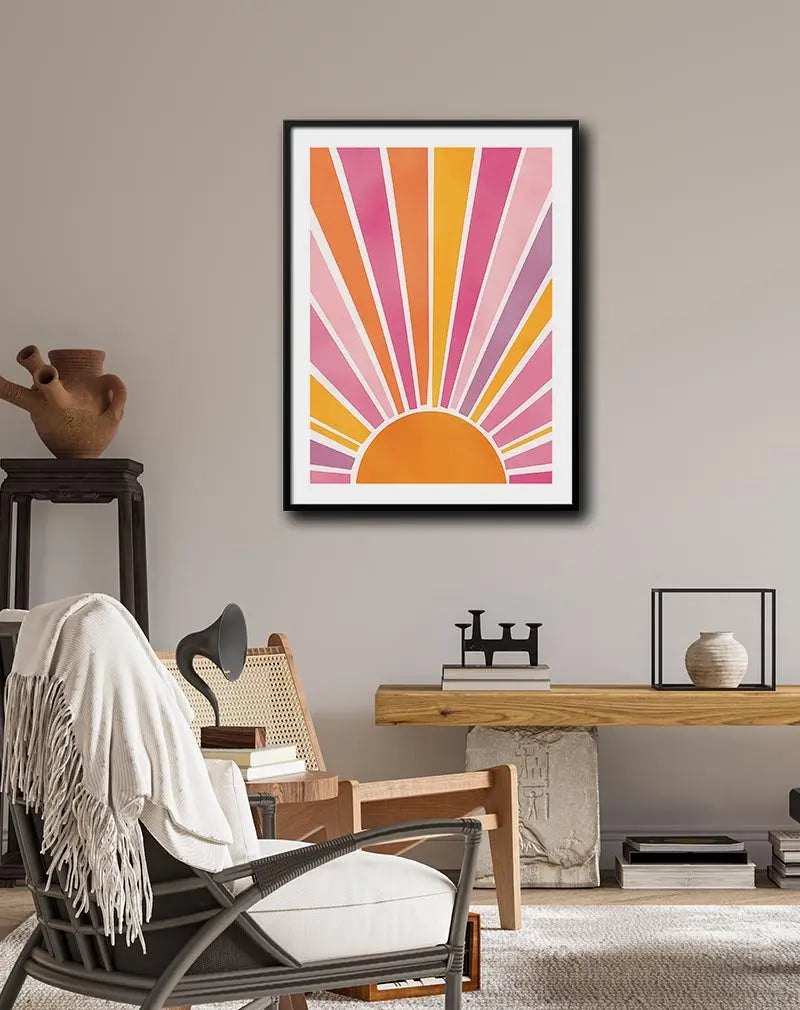 A vibrant illustration of an abstract sunrise with rays of pink, orange, and yellow spreading out. Perfect wall art to add a touch of warmth and energy to your space, ideal for brightening up any room