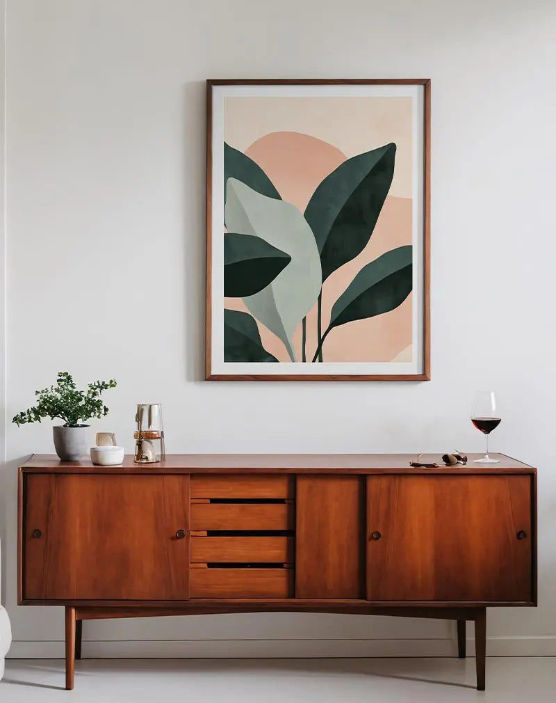 An abstract illustration featuring green and beige leaves against a soft pink background. Perfect wall art for bringing a natural and modern feel to your space.