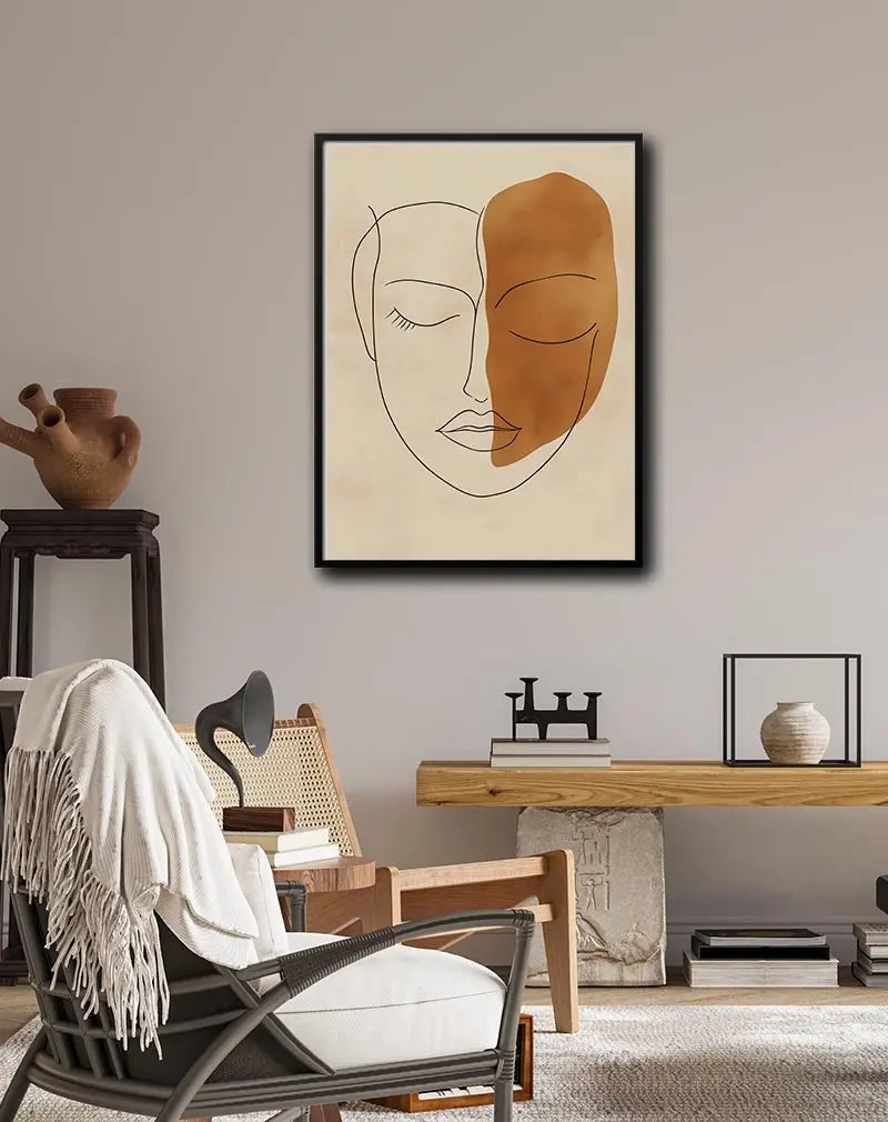 A minimalist line art of a face with a bold abstract brown shape covering half of it. Perfect wall art for a modern and elegant touch in living spaces or creative studios